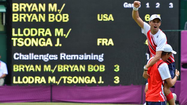 American doubles team Mike Bryan (top) and Bob Bryan celebrate after defeating France's Michael Llodra and Jo-Wilfried Tsonga in the men's doubles gold medal match of the London 2012 Olympic Games, at the All England Tennis Club.