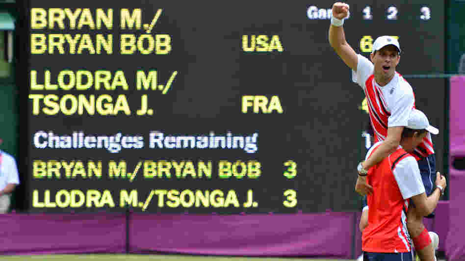 American doubles team Mike Bryan (top) and Bob Bryan celebrate after defeating France's Michael Llodra and Jo-Wilfried Tsonga in the men's doubles gold medal match of the London 2012 Olympic Games, at the All England Tennis Club.