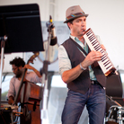 Saxophonist Peter Apfelbaum (center) plays the melodica at the 2012 Newport Jazz Festival, accompanied by Yunior Terry (left) on bass and Dafnis Prieto (right) on drums. Saxophonist Peter Apfelbaum (center) plays the melodica at the 2012 Newport Jazz Festival, accompanied by Yunior Terry (left) on bass and Dafnis Prieto (right) on drums.