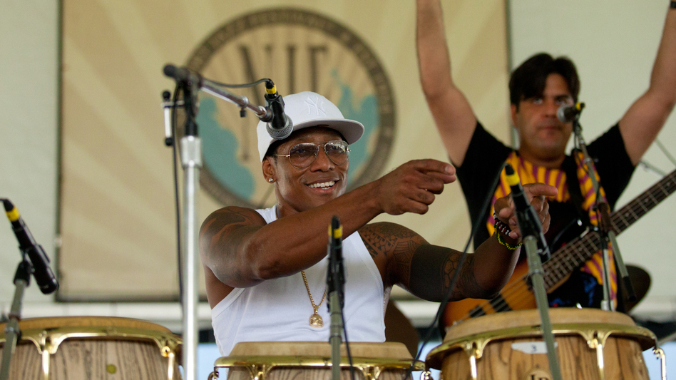Vocalist and conguero Pedrito Martinez (center) performs with bassist Alvaro Benavides (right) at the 2012 Newport Jazz Festival.