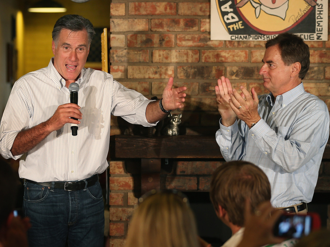 U.S. Senate candidate Richard Mourdock, right, applauds as Republican presidential candidate Mitt Romney speaks during a campaign event at Stepto's Bar-B-Q Shack in Evansville, Ind., Saturday.