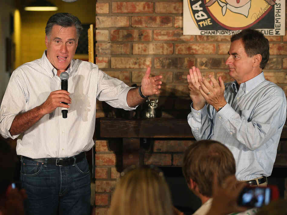 U.S. Senate candidate Richard Mourdock, right, applauds as Republican presidential candidate Mitt Romney speaks during a campaign event at Stepto's Bar-B-Q Shack in Evansville, Ind., Saturday.