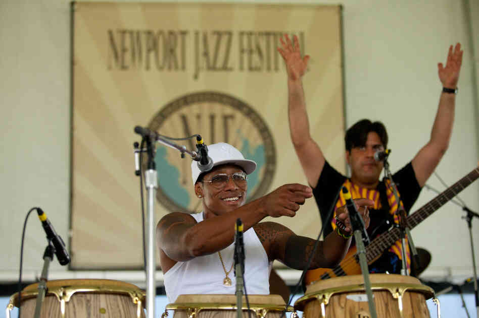 Before noon Saturday, the quartet led by charismatic conguero Pedrito Martinez had its audience gyrating to Afro-Cuban rhythms. Bassist Alfaro Benavides provides additional encouragement from the stage.
