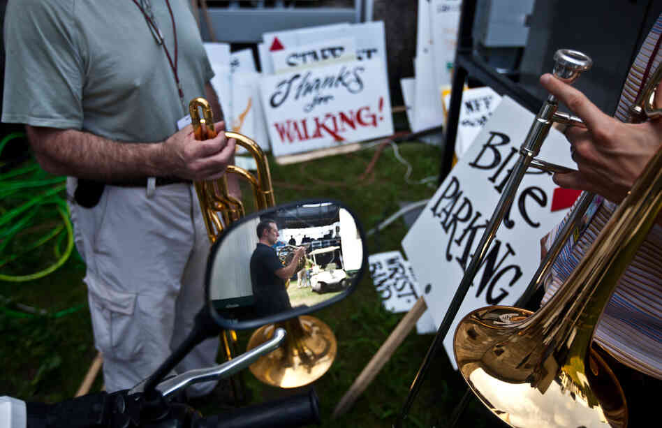 Members of the Ryan Truesdell's Gil Evans Centennial Project, including David Peel on French horn and Ryan Keberle on trombone, hang out backstage at the Newport Jazz Festival.