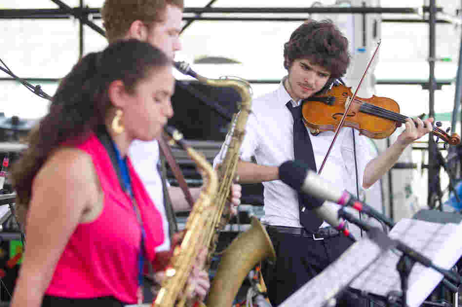 The Berklee Global Jazz Ambassadors feature students from around the world, including saxophonists Lihi Haruvi (left) and Matthew Halpin (center) and violinist Alex Hargreaves. Professional drummer Adam Cruz anchored their Fort Stage performance.