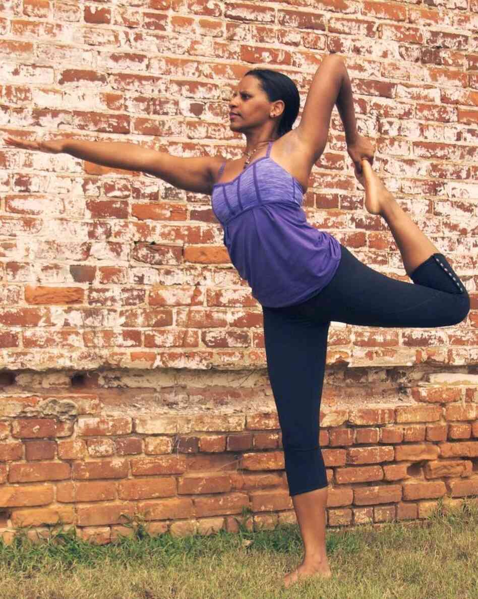 Yoga instructor Dara Brown stretches — and stretches her students, too.
