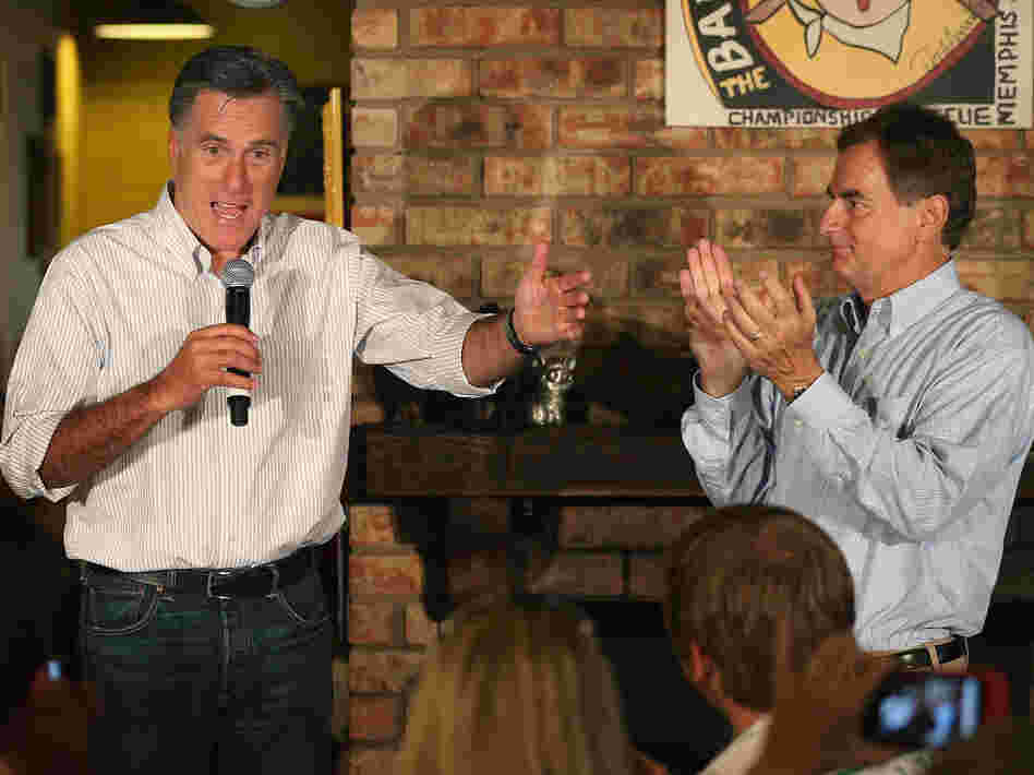 U.S. Senate candidate Richard Mourdock listens to Mitt Romney last week in Evansville, Ind.