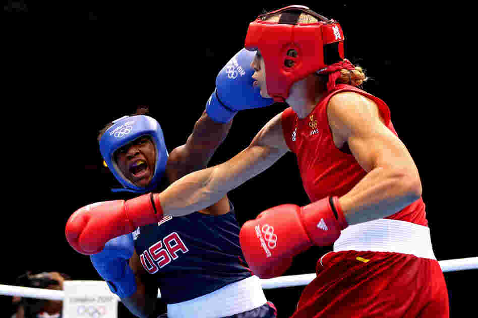 U.S. boxer Claressa Shields (in blue) competes against Sweden's Anna Laurell during the women's middleweight boxing quarterfinals. Shields won the bout and will move on to the semifinal round.