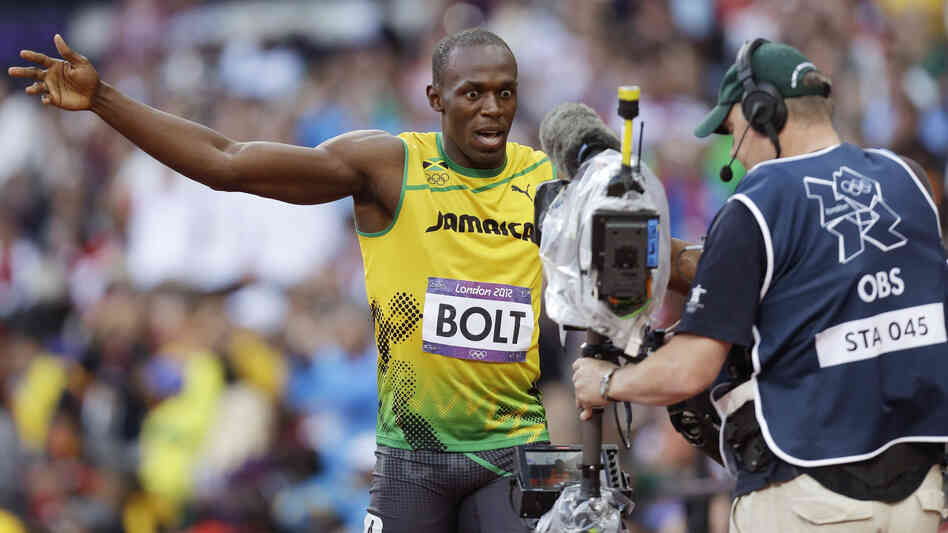 Jamaica's Usain Bolt gestures to a camera after running in an Olympic 100-meter semifinal. There's no telling when Americans might have seen his actions, as NBC tape-delays top events. Online, fans are finding ways around the network's strategy.