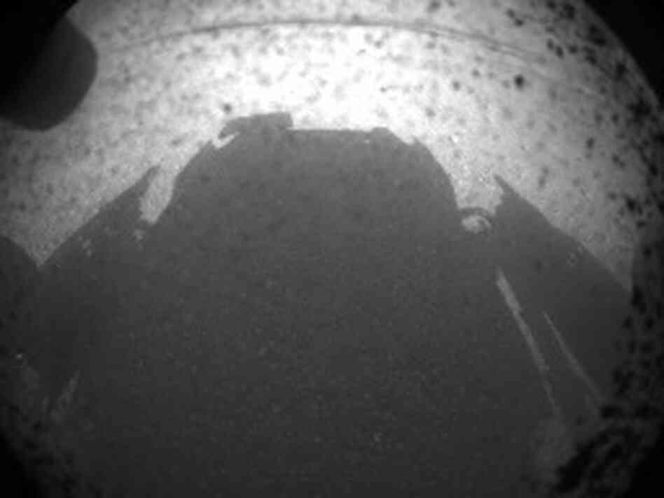 Curiosity's shadow on the surface of Mars, just minutes after the rover landed on the surface of the planet. Curiosity's shadow on the surface of Mars, just minutes after the rover landed on the surface of the planet.