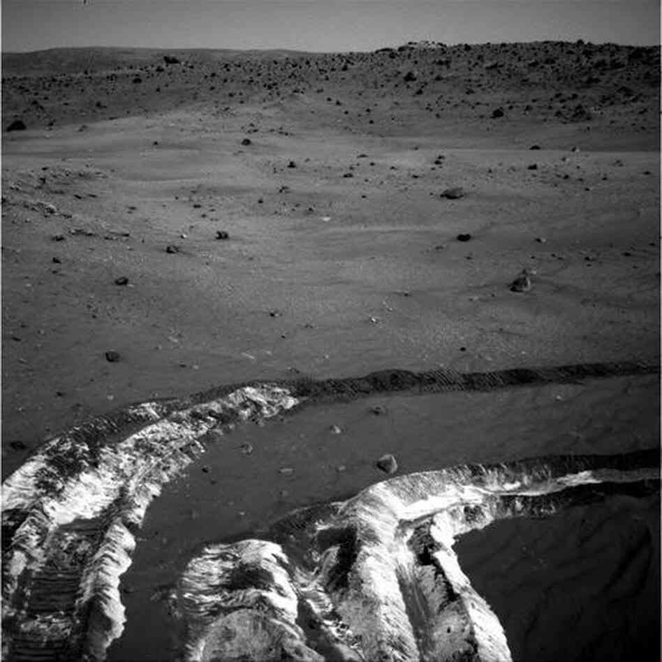 While driving eastward toward McCool Hill, the wheels of Spirit churned up the largest amount of bright soil discovered so far in the mission, in 2006. The soil salts may record the past presence of water.