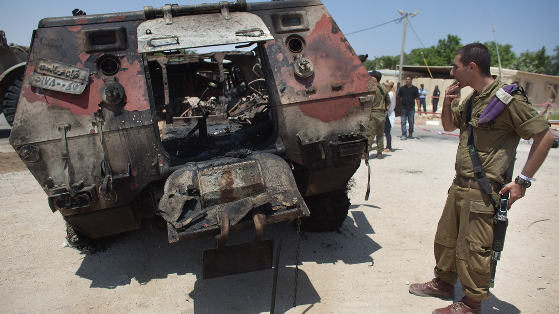 Militants drove two armored vehicles through a security fence into Israel from Egypt on Sunday, leaving 16 Egyptian soldiers dead and destroying two armored vehicles. An Israeli soldier inspects the wreckage of one of the Egyptian military trucks at a base in Kerem Shalom, Israel.