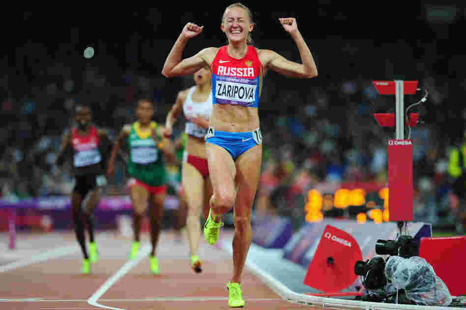 Yuliya Zaripova of Russia celebrates as she crosses the finish line to win the gold medal in the women's 3,000-meter steeplechase final.