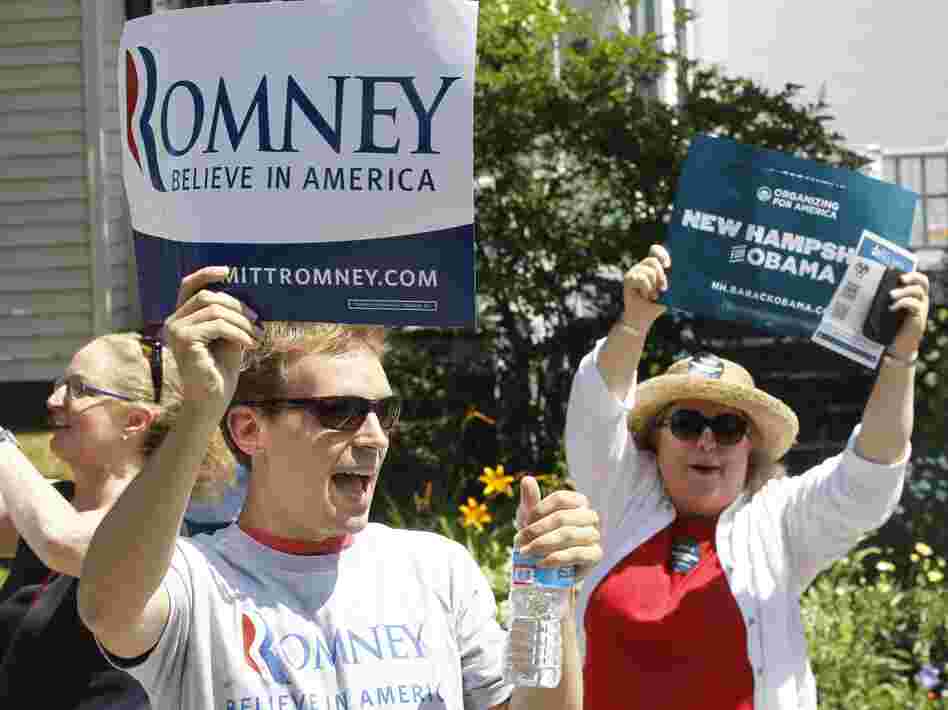Supporters of President Obama shout as Republican presidential candidate Mitt Romney walks in the Fourth of July Parade in Wolfeboro, N.H.