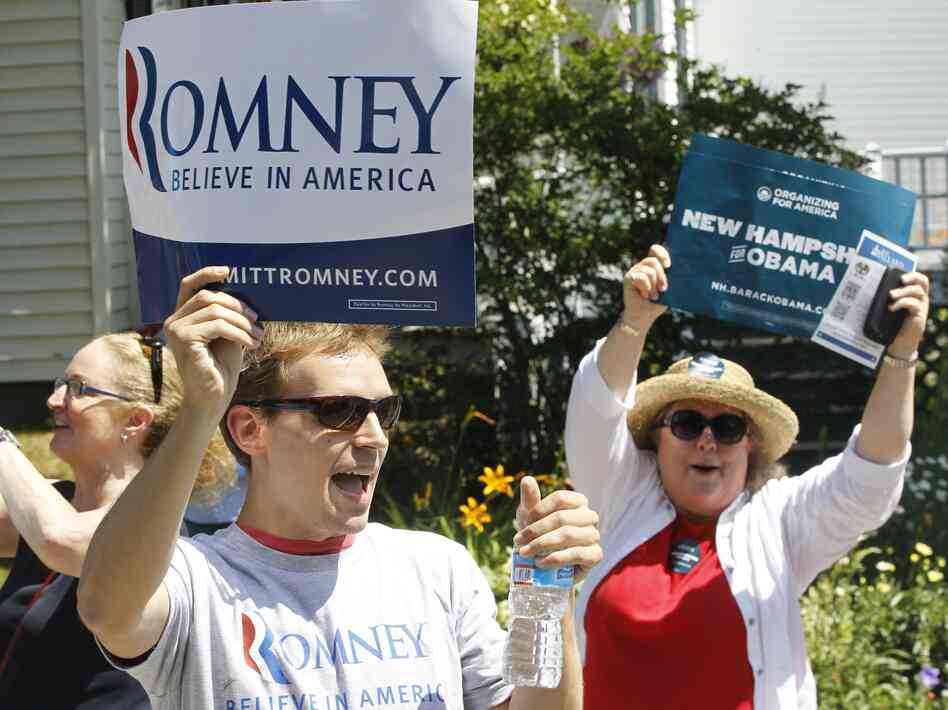 Supporters of President Obama shout as Republican presidential candidate Mitt Romney walks in the Fourth of July Parade in Wolfeboro, N.H.