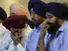 Members of the Sikh Temple of Wisconsin react at a news conference at Oak Creek Centennial church in Oak Creek, Wis. on Monday. Members of the Sikh Temple of Wisconsin react at a news conference at Oak Creek Centennial church in Oak Creek, Wis. on Monday.
