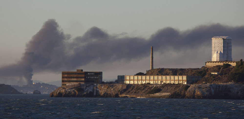 Smoke poured from the fire at a Chevron refinery in Richmond, Calif. Here, the plume rises behind Alcatraz Island in San Francisco.