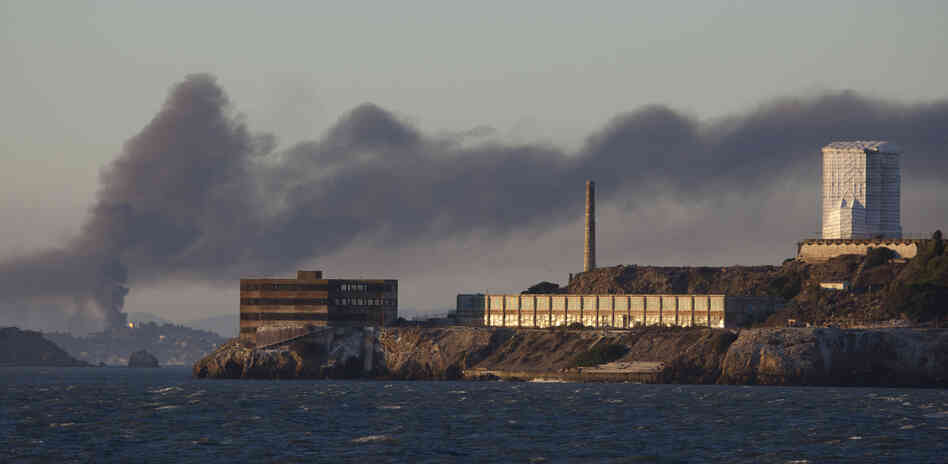 Smoke poured from the fire at a Chevron refinery in Richmond, Calif. Here, the plume rises behind Alcatraz Island in San Francisco.