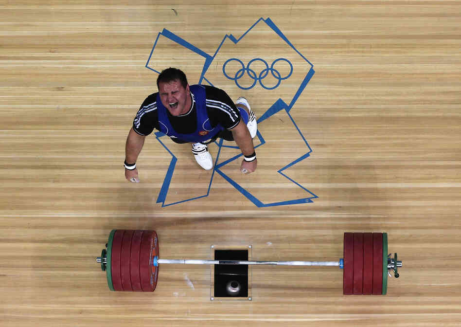 Ruslan Albegov of Russia reacts after completing one of his lifts during the men's 105-kilogram weightlifting final. He finished third in the event.