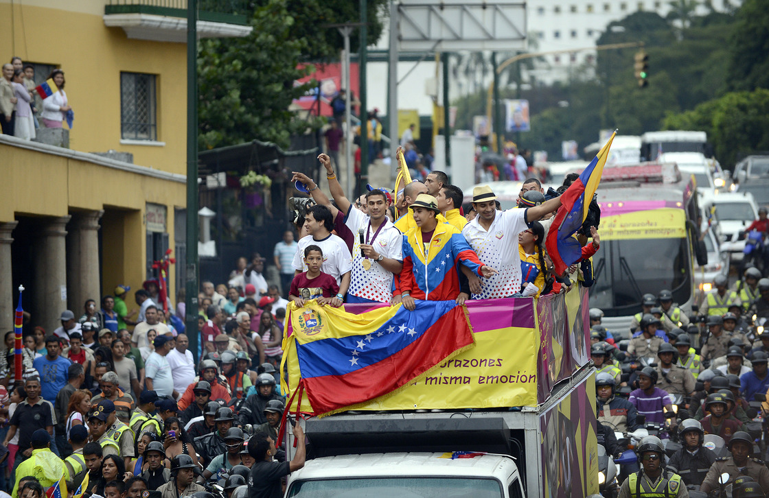 Venezuelan gold medal fencer Ruben Limardo (center) greets supporters after arriving in Caracas Monday. Limardo was received at the airport as a national hero, after winning the first gold medal for Venezuela in 44 years.