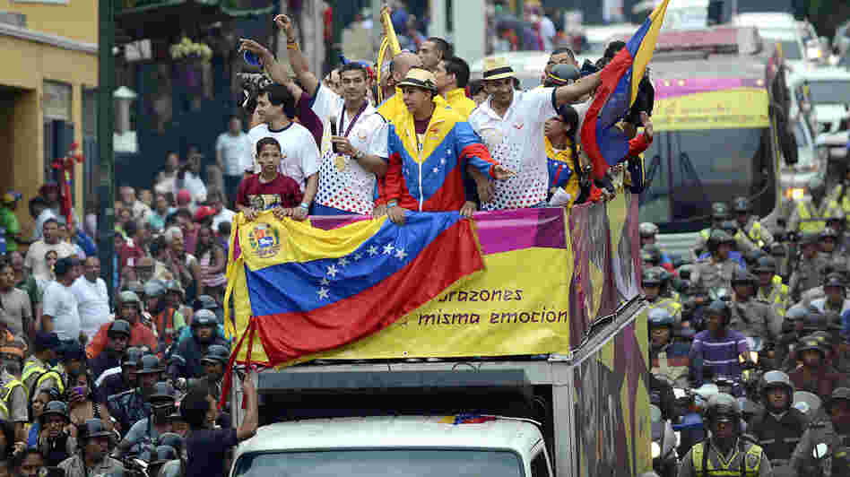 Venezuelan gold medal fencer Ruben Limardo (center) greets supporters after arriving in Caracas Monday. Limardo was received at the airport as a national hero, after winning the first gold medal for Venezuela in 44 years.