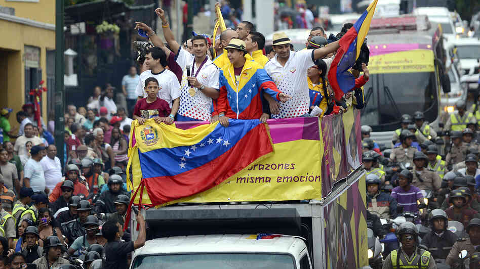 Venezuelan gold medal fencer Ruben Limardo (center) greets supporters after arriving in Caracas Monday. Limardo was received at the airport as a national hero, after winning the first gold medal for Venezuela in 44 years.