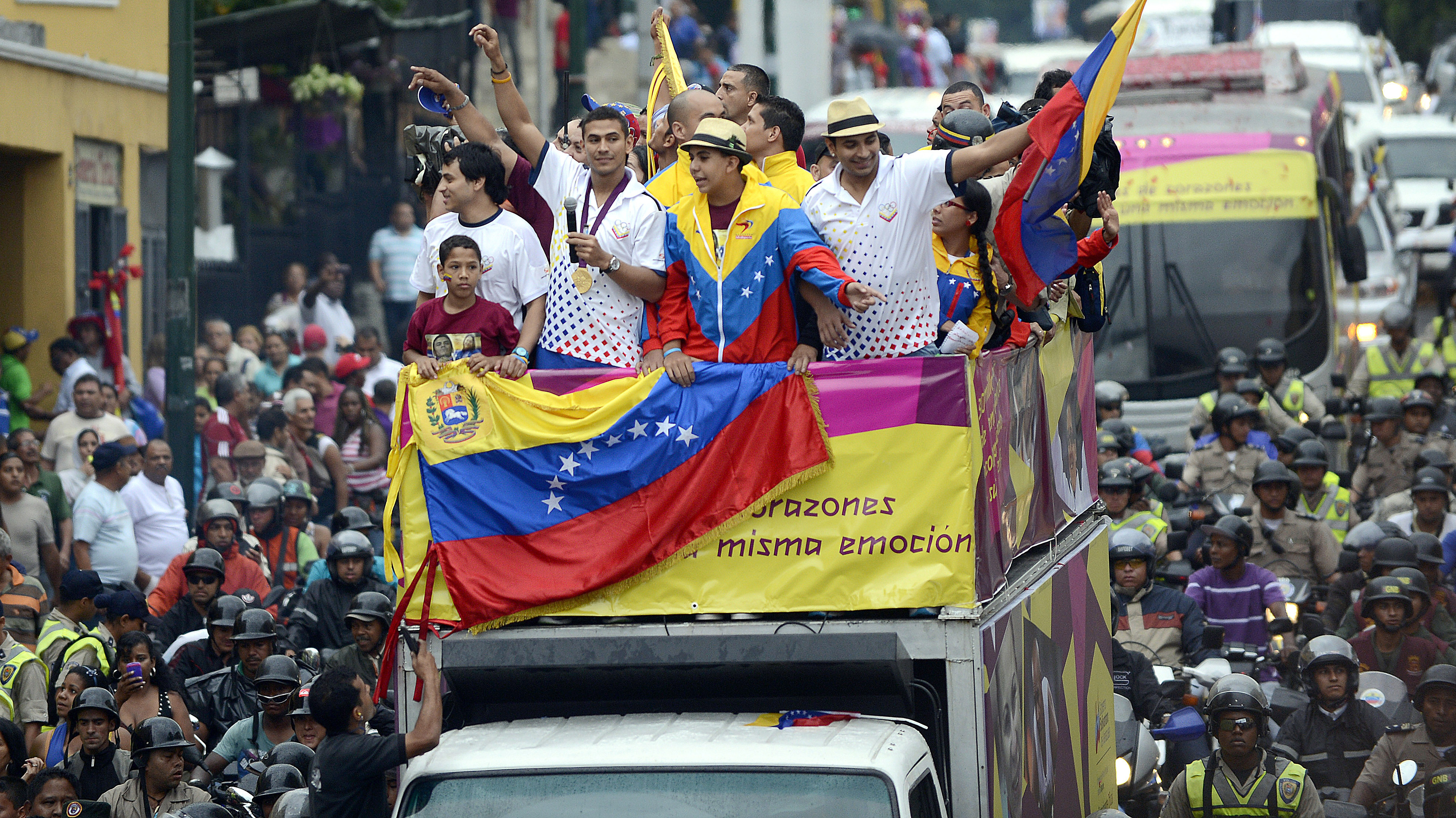 Venezuelan gold medal fencer Ruben Limardo (center) greets supporters after arriving in Caracas Monday. Limardo was received at the airport as a national hero, after winning the first gold medal for Venezuela in 44 years.