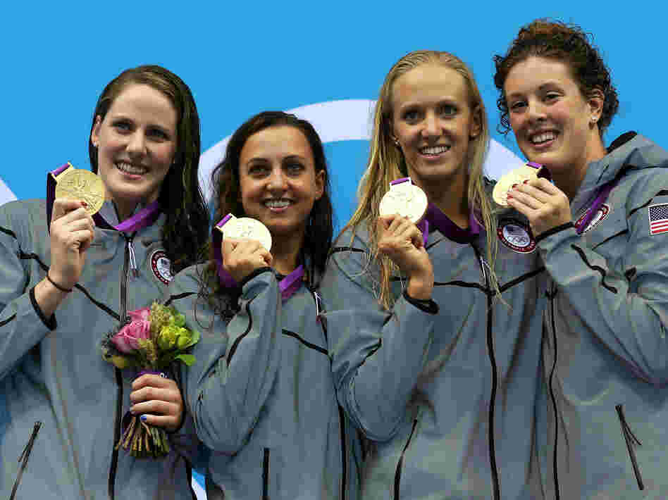 U.S. gold medallists pose on the podium after their world-record 4x100m medley relay final. U.S. gold medallists pose on the podium after their world-record 4x100m medley relay final.