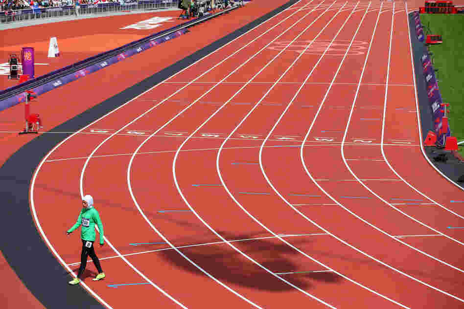Sarah Attar of Saudi Arabia walks off the track after competing in the Women's 800m Round 1 Heats.