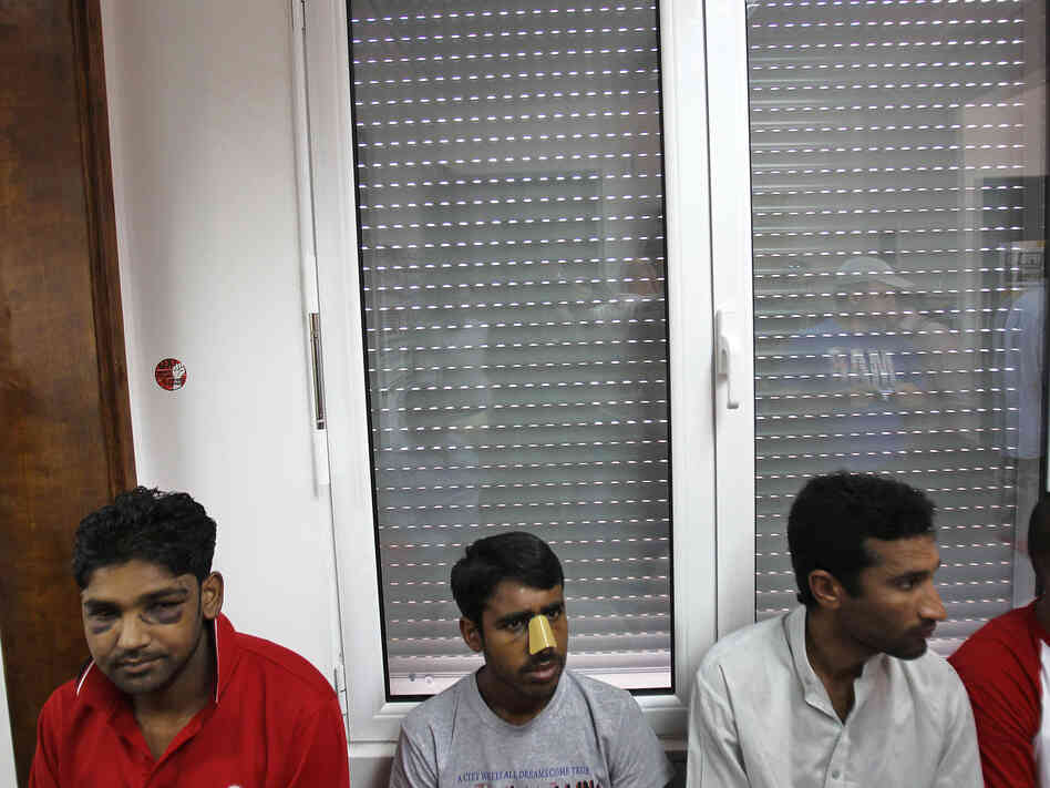 Immigrants at a news conference in Athens on June 21 say they were attacked by members of the extreme-right Golden Dawn party. United Against Racism and Fascist Violence Movement, an immigrants-support group, says Golden Dawn is behind attacks on hundreds of immigrants to Greece.