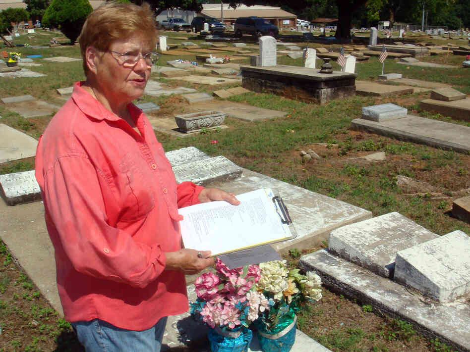 Phyllis Armstrong holds a list of graves she's trying to locate at Lincoln Cemetery.