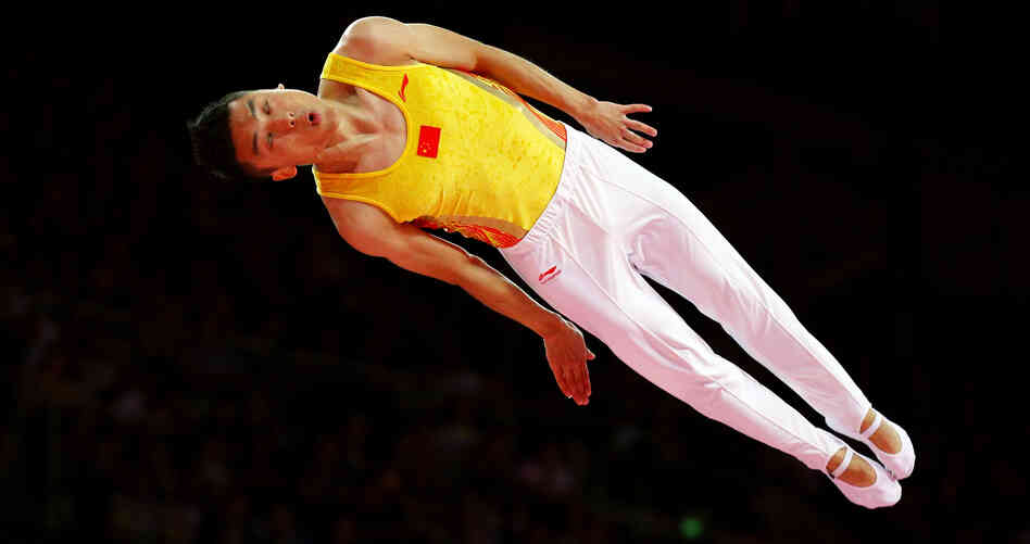 Chinese trampoline gold medalist Dong Dong competes in London. An analysis by Yahoo finds that China's Olympians outpace their U.S. counterparts in judged competitions, such as trampoline and diving.