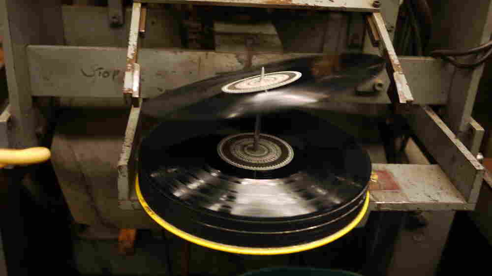 A 12-inch record tips onto the spindle at EKS Manufacturing. A 12-inch record tips onto the spindle at EKS Manufacturing.