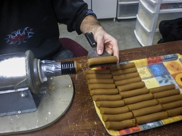 Soybean paste is extruded into 350 gram segments for testing in toilets.