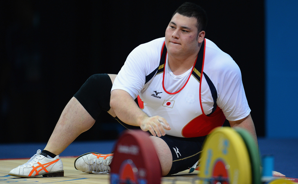 Weightlifter Kazuomi Ota of Japan takes a moment after failing to lift the required weight in the men's +105kg  final in London. At 6 feet and 324 pounds, Ota is one of the largest Olympians.