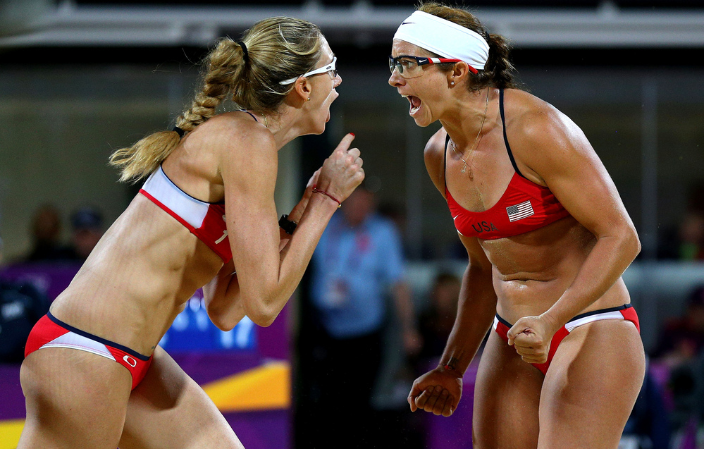 Americans Kerri Walsh Jennings (left) and Misty May-Treanor yell after winning a record third-straight gold medal in women's beach volleyball, at the Horse Guard's Parade in London.