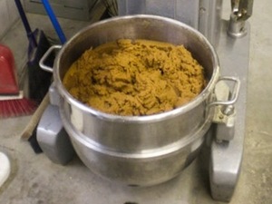 Soybean paste is mixed to the right consistency and moisture content to produce fake poop at the Maximum Performance factory.