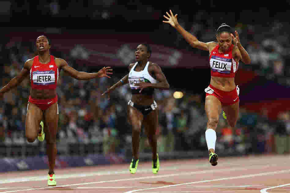 Allyson Felix of the U.S. crosses the finish line ahead of Murielle Ahoure of Cote d'Ivoire and Carmelita Jeter of the U.S. to win the women's 200-meter final.