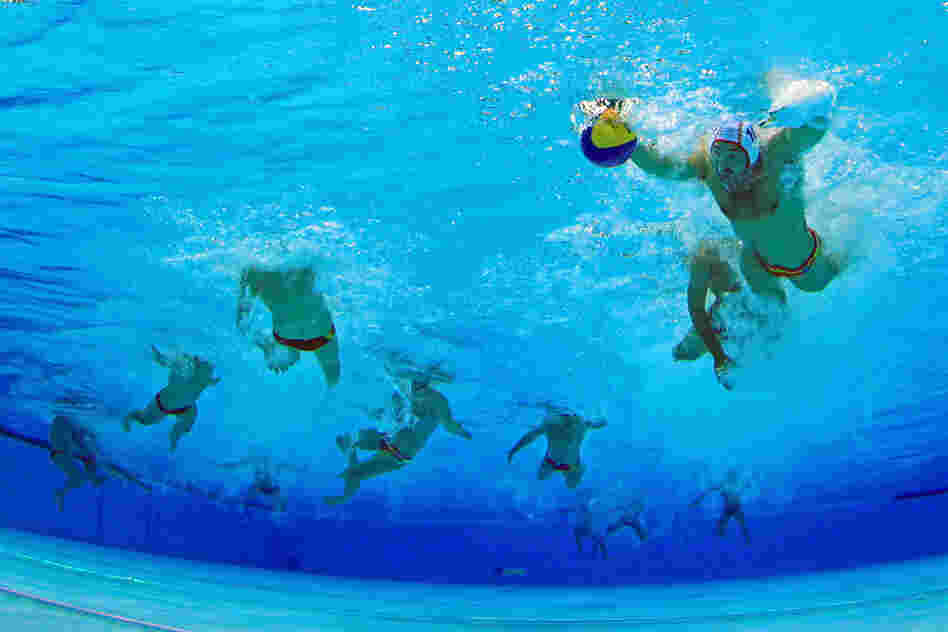 Felipe Perrone Rocha of Spain controls the ball in the men's water polo quarterfinal match between Montenegro and Spain. Montenegro won 11-9.