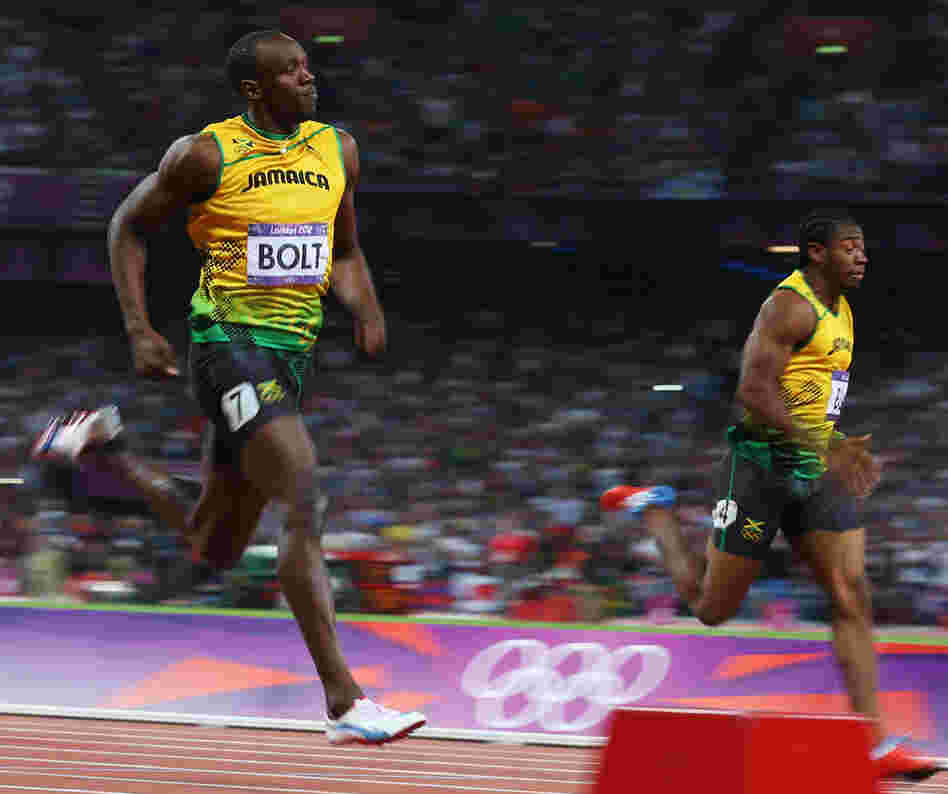 Usain Bolt of Jamaica crosses the finish line ahead of Yohan Blake of Jamaica to win gold during the Men's 200m Final.