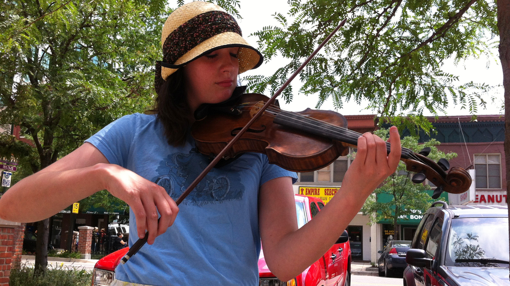 Alexis Dawdy plays her violin on the streets of Lansing, Mich.