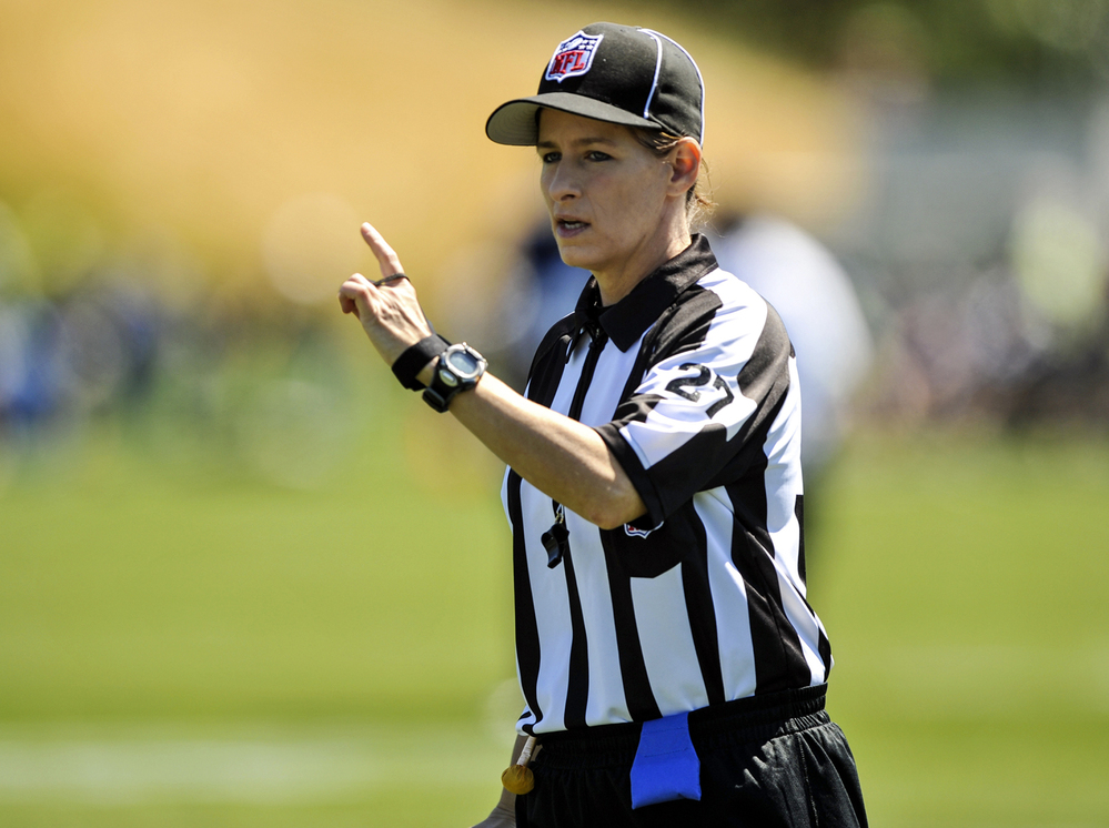 In this photo taken on Saturday, Aug. 4, 2012, and provided by the Seattle Seahawks, NFL official Shannon Eastin works during the Seahawks NFL football training camp in Renton, Wash.