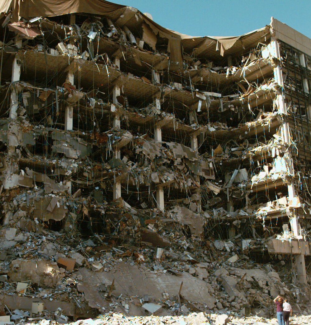 Rescue workers stand in front of the Alfred P. Murrah Federal Building in Oklahoma City after an explosion on April 19, 1995. The bombing killed 168 people.