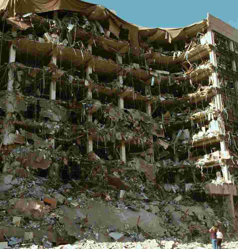 Rescue workers stand in front of the Alfred P. Murrah Federal Building in Oklahoma City after an explosion on April 19, 1995. The bombing killed 168 people.