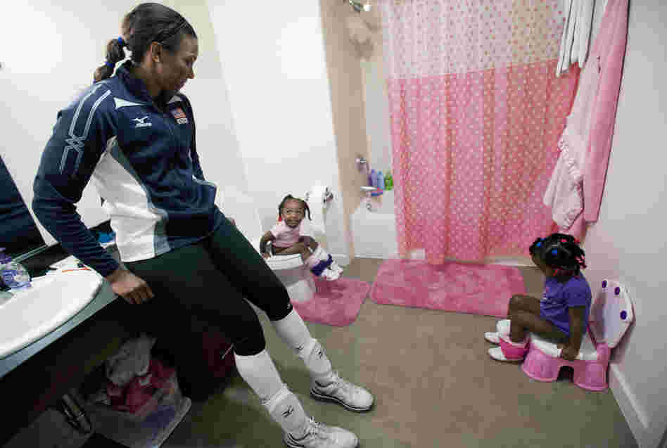 Danielle Scott-Arruda helps her grandniece Madison (left) and daughter Julianne in the bathroom. Scott-Arruda is a volleyball player on the U.S. Olympic team.