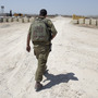An Israeli soldier walks near the border between Israel and Egypt at the Kerem Shalom border crossing on Wednesday. An Israeli soldier walks near the border between Israel and Egypt at the Kerem Shalom border crossing on Wednesday.