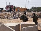 Israeli soldiers look at their Egyptian counterparts from their side of the border Wednesday at the Kerem Shalom border crossing, where an attack by Islamist militants on Sunday killed 16 Egyptian soldiers. Israeli soldiers look at their Egyptian counterparts from their side of the border Wednesday at the Kerem Shalom border crossing, where an attack by Islamist militants on Sunday killed 16 Egyptian soldiers.