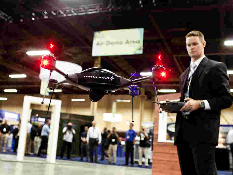 Brian Bills, a flight operations analyst for Lockheed Martin, demonstrates the Procerus VTOL (vertical takeoff and landing) Flight System — a surveillance drone for commercial, civil and military customers — at the Association of Unmanned Vehicle Systems International conference in Las Vegas. (Watch a demo video.)