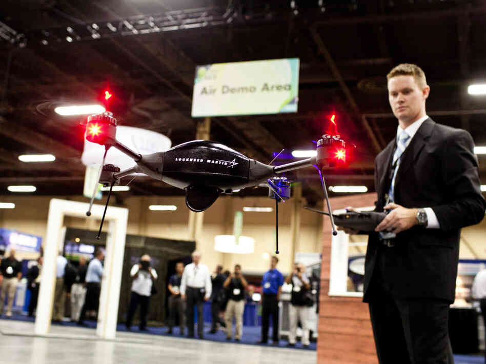 Brian Bills, a flight operations analyst for Lockheed Martin, demonstrates the Procerus VTOL (vertical takeoff and landing) Flight System — a surveillance drone for commercial, civil and military customers — at the Association of Unmanned Vehicle Systems International conference in Las Vegas. (Watch a demo video.)