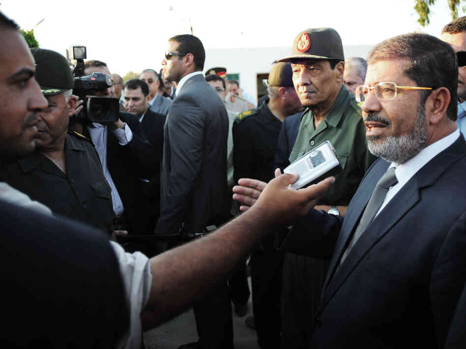 Egyptian President Mohammed Morsi (right) speaks to the media on Aug. 6 in El Arish, Egypt. He has already been engaging with the public more regularly than his predecessor.